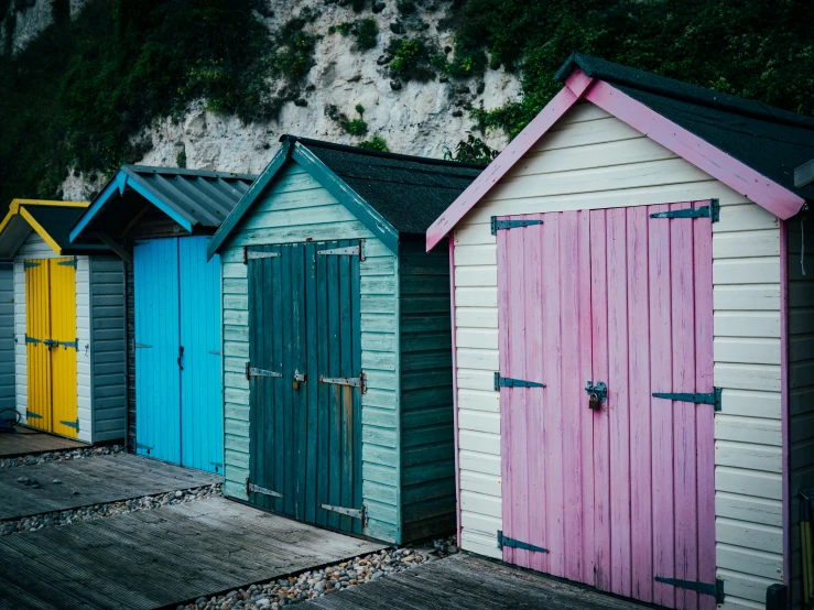 different colored beach houses on a sandy area