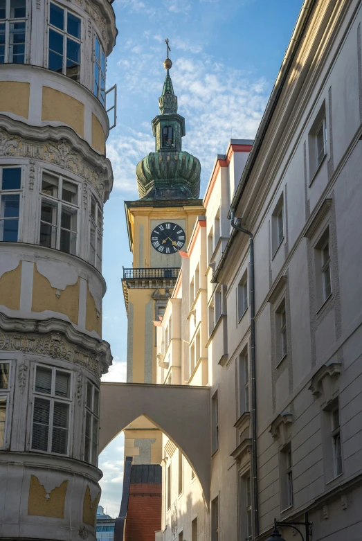 a building with a clock on it near another building