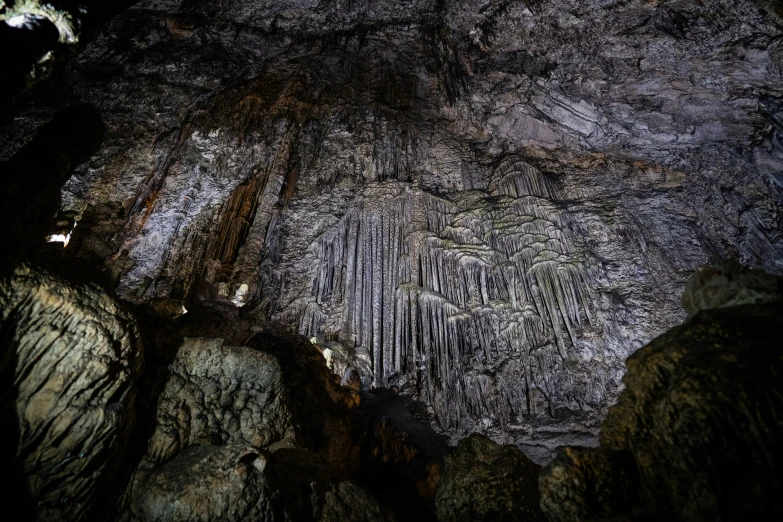 an ornate cave entrance lit up by moonlight