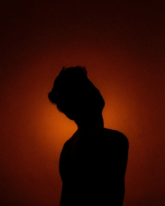 a silhouette of a person in the dark