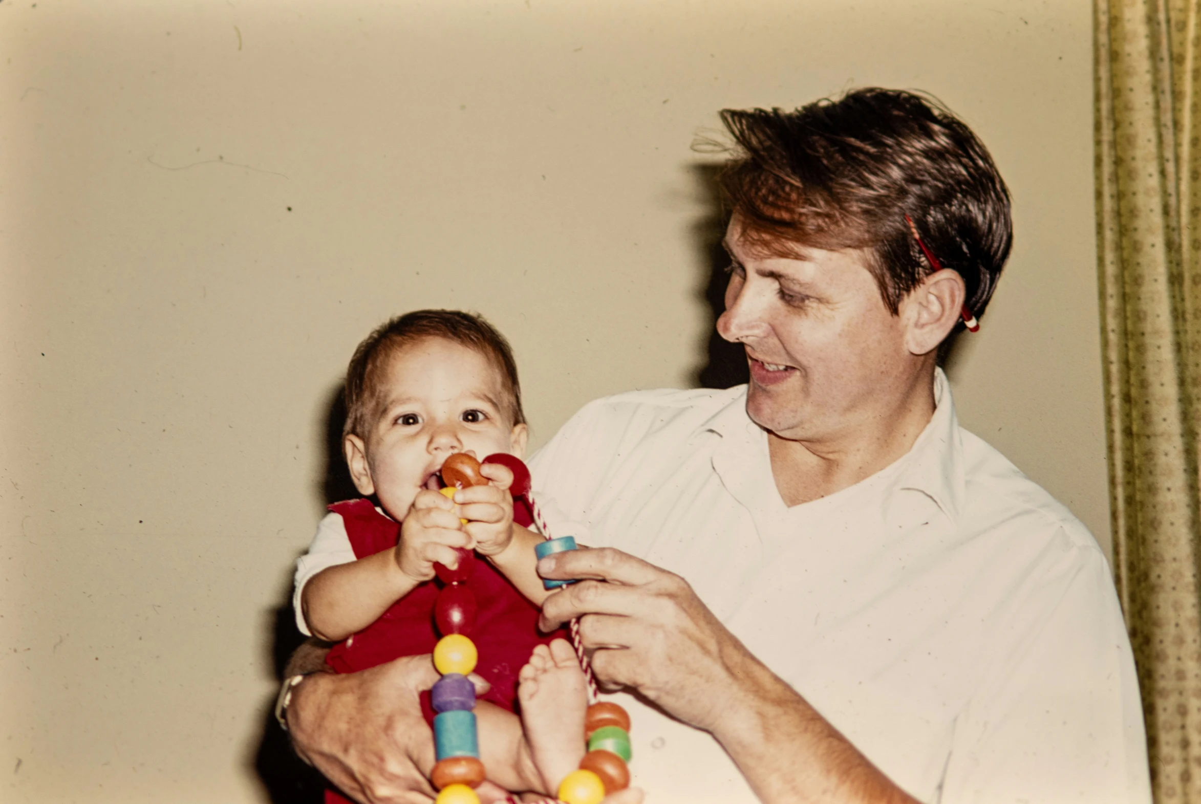 a young man is playing with a child