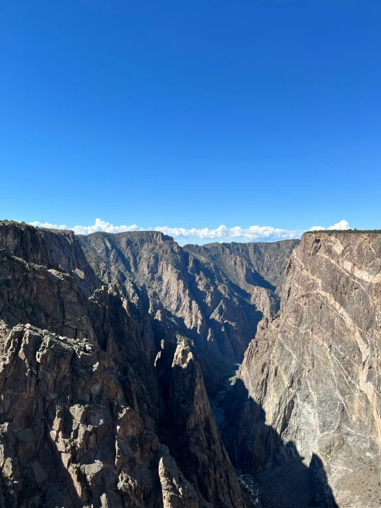 the cliff that holds a bunch of trees next to the mountain