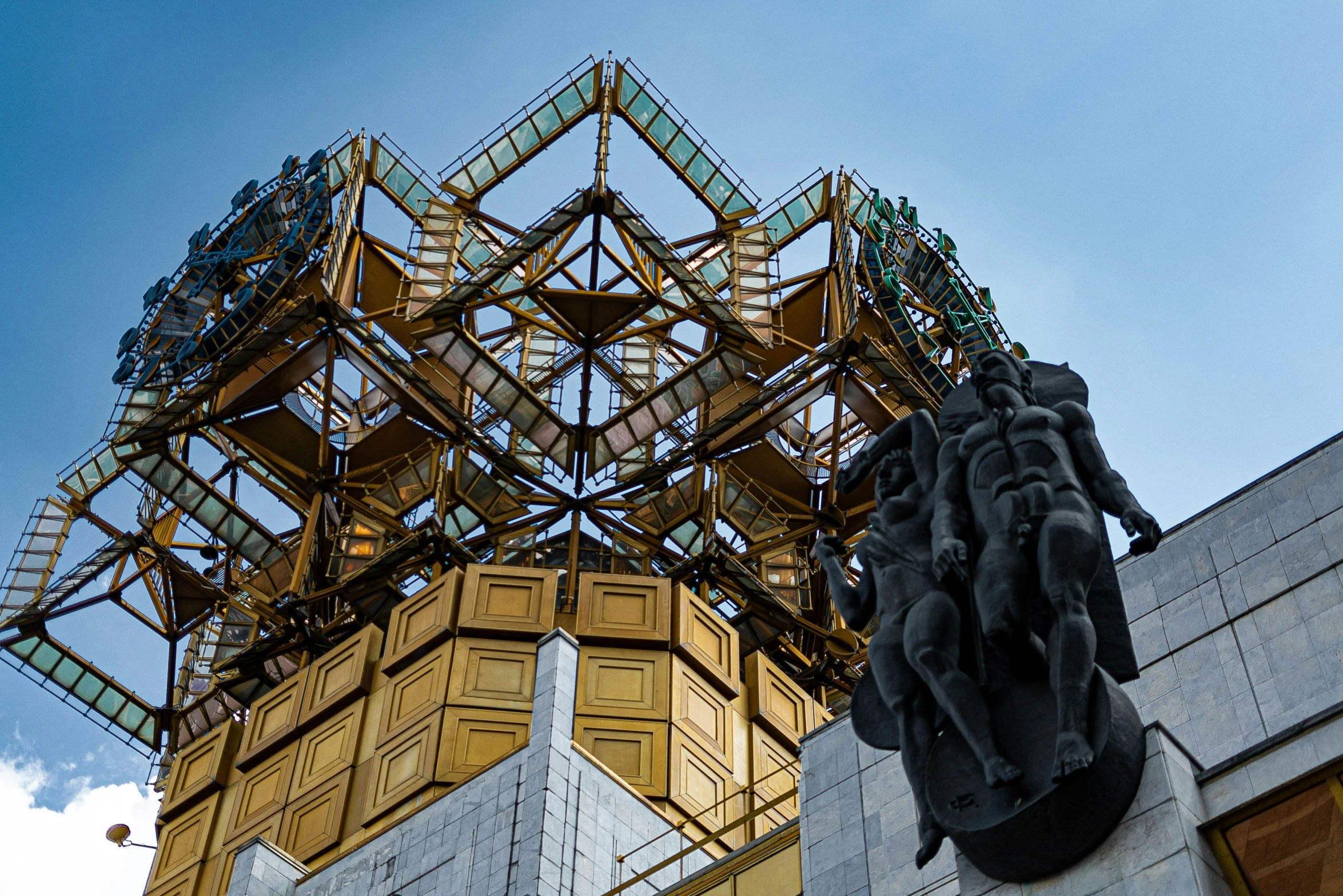 a sculpture with a golden tower of books on top