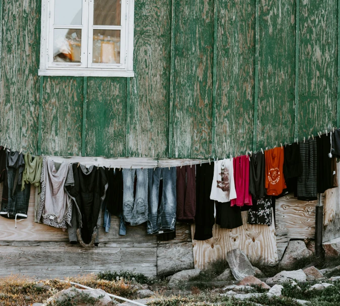 clothes drying out on clothes line outside green shed