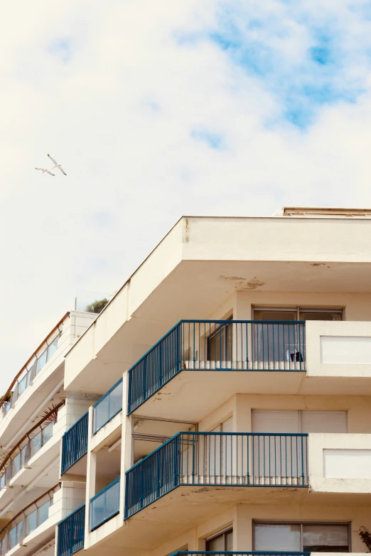 a balcony with railings and a blue balconies on the upper floor