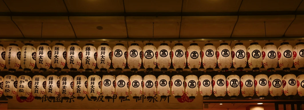 a row of asian lanterns are hanging in the room