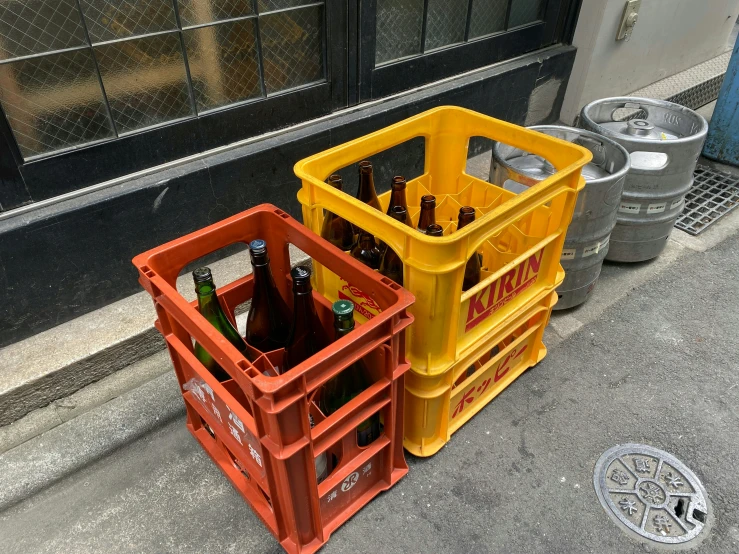 the sidewalk on the street has several plastic crates on it