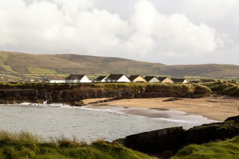 the coast near houses on an island in the far distance