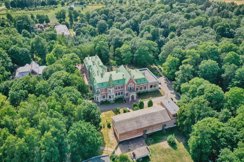 an aerial view of an old building in a forest