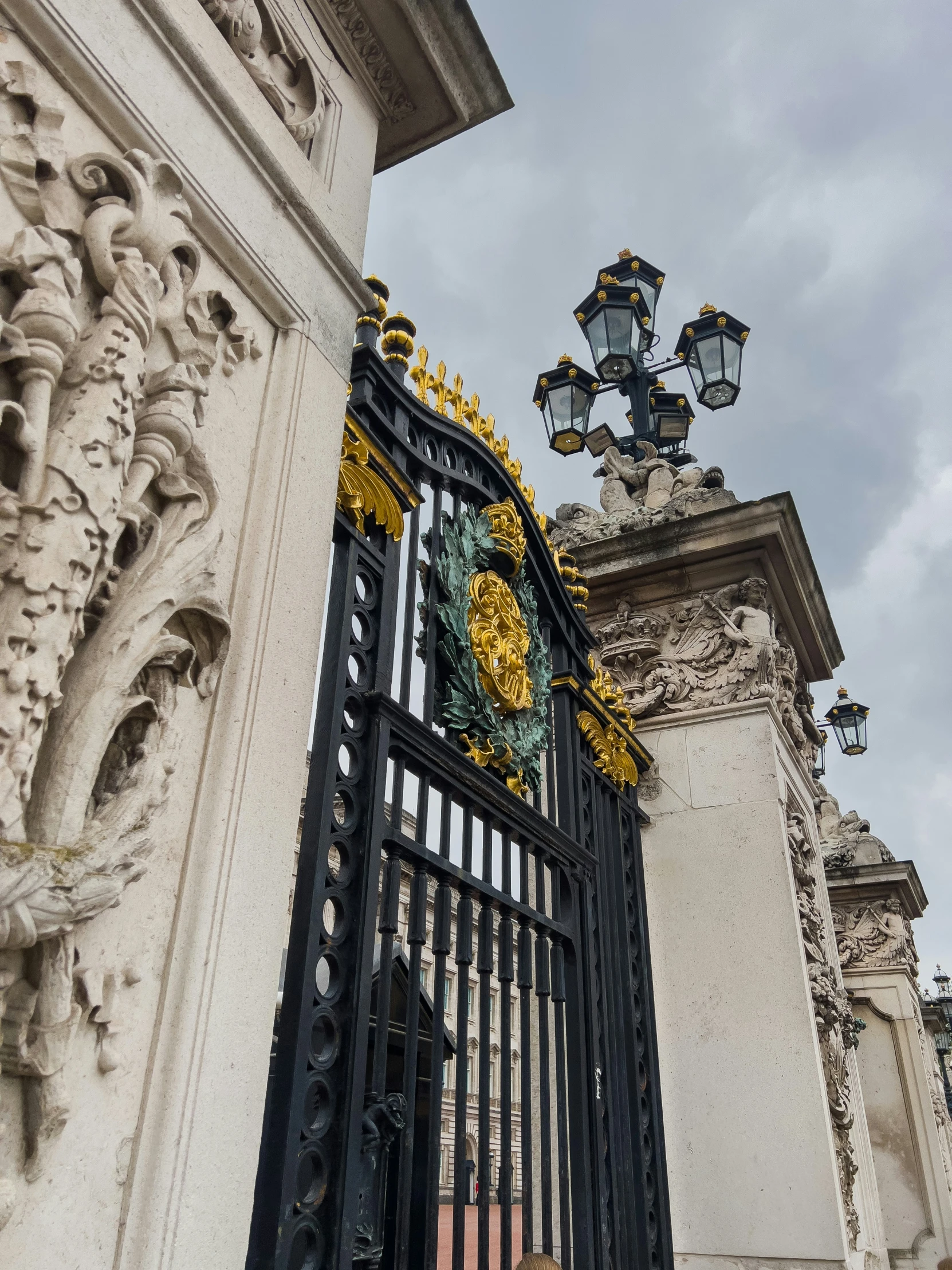 a statue on top of a building next to a gate