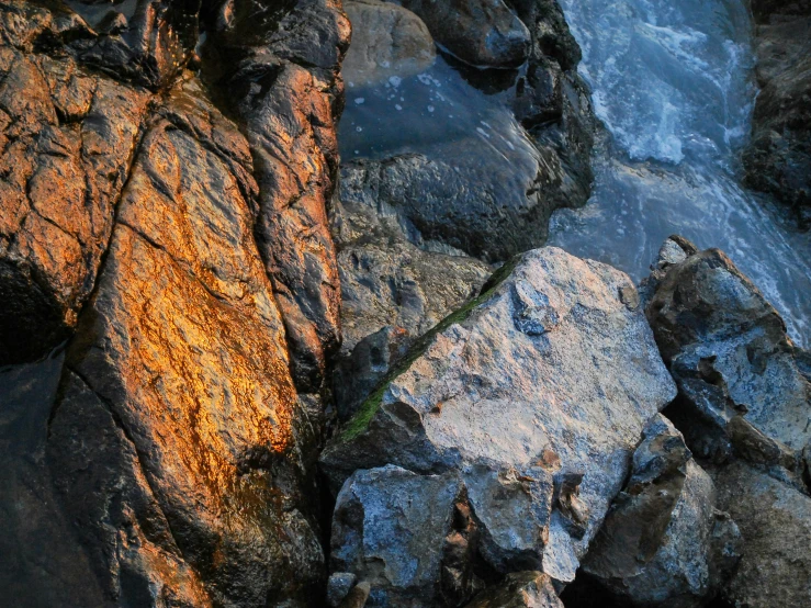 a rock is shown on the rocks by the water