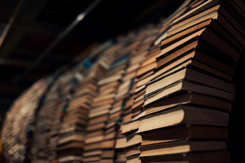 a stack of books sitting on top of a wooden table