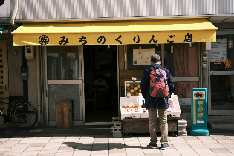 a woman is walking in front of the store