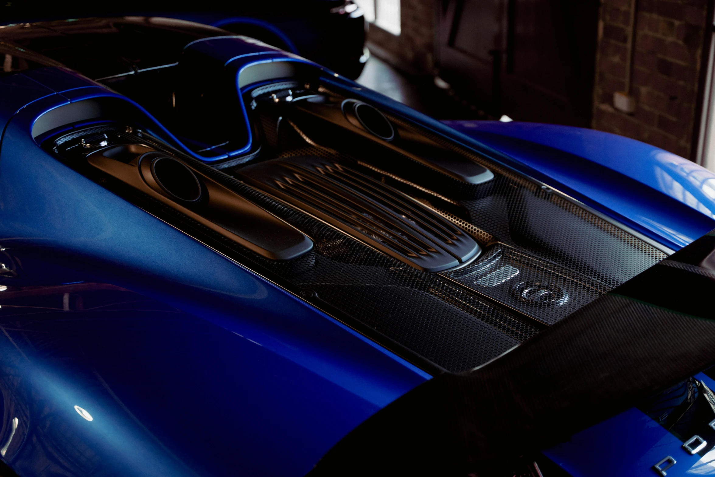 the engine compartment of a blue sports car