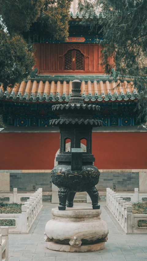 the ancient fountain stands in front of an oriental temple