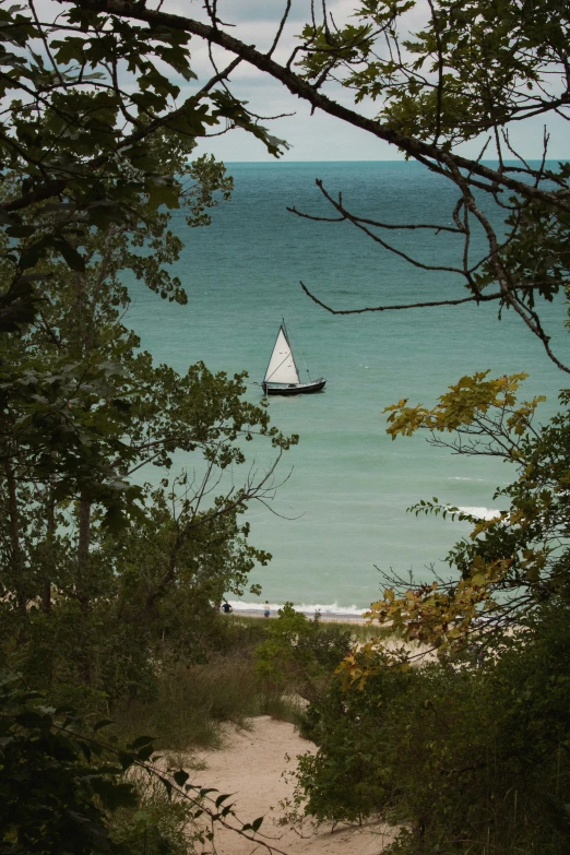 a boat is floating in the ocean by a path