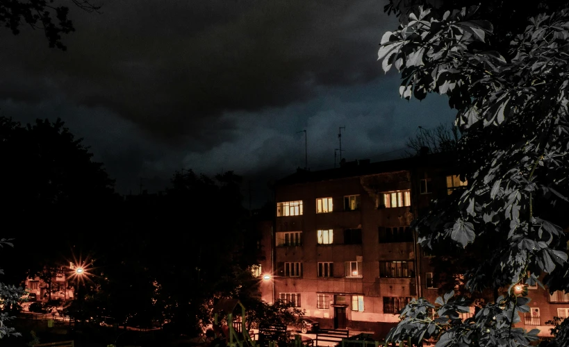 the night time view of a large brick building