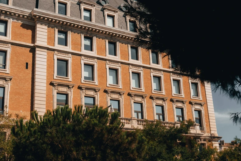 a brown and tan building with many windows