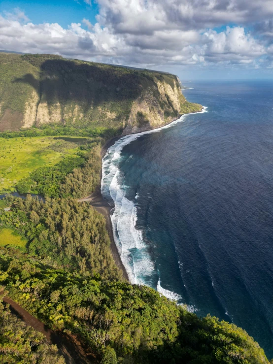 the view from a hill on a steep cliff overlooking the ocean