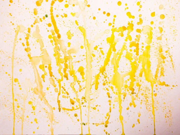 yellow water splashes are on the white wall