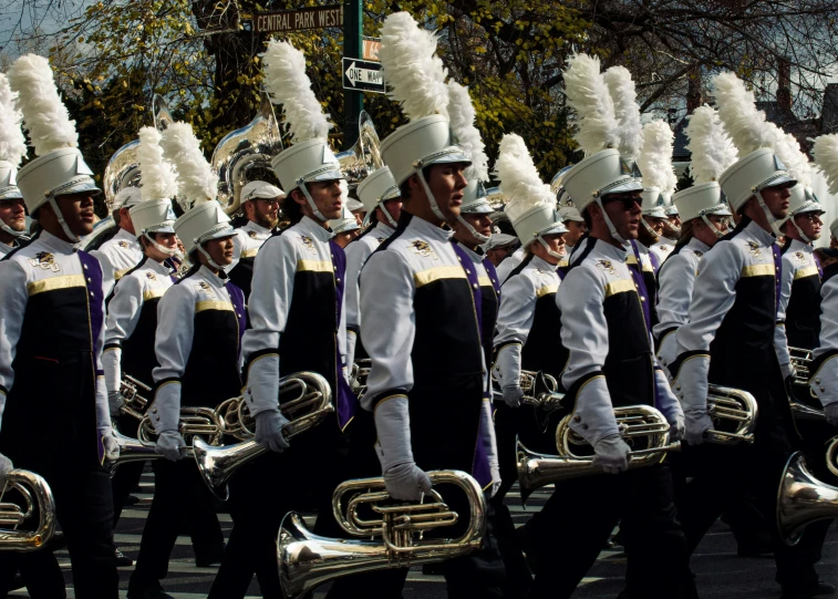 the band is dressed in a white and purple outfit