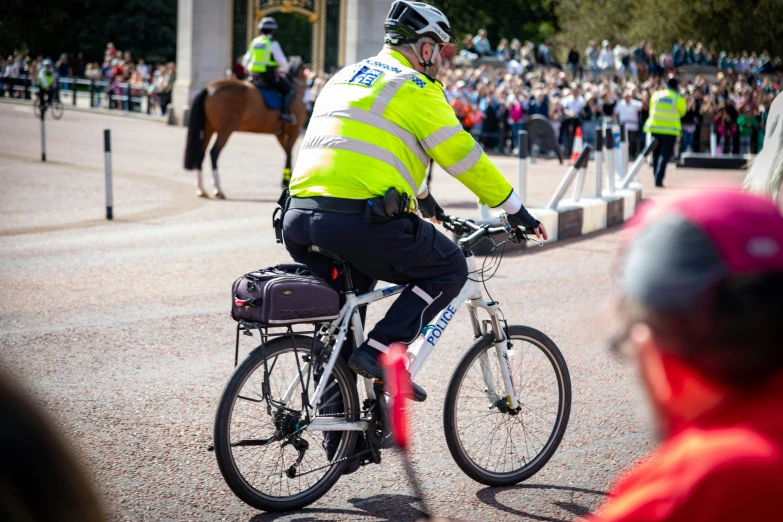 a person on a bike riding in front of a crowd