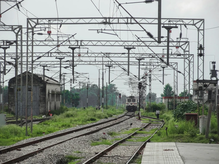 an abandoned train station, some run down tracks and other buildings