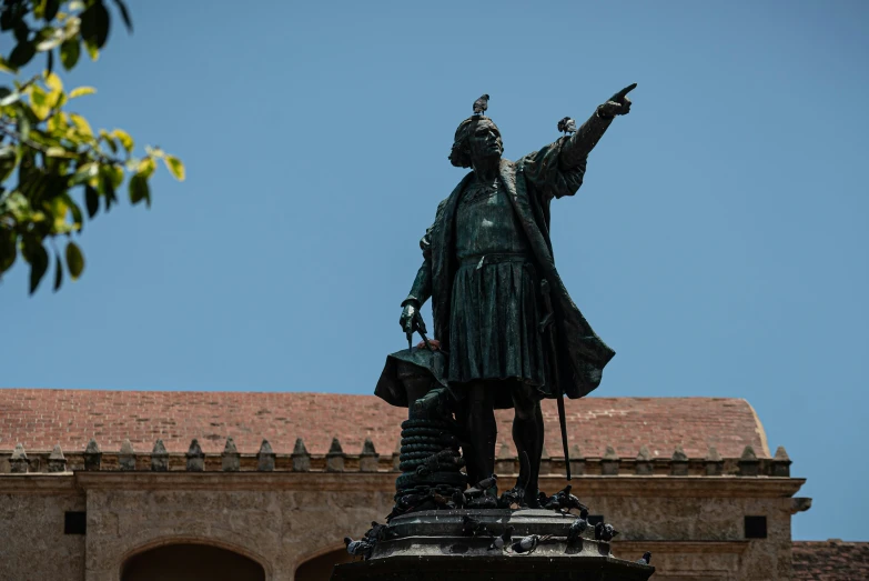 the statue is standing with a hat in his hand