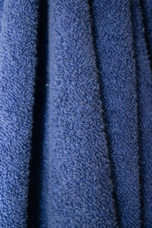 a very shiny blue towel on the floor