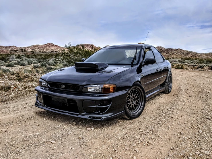 black modified car sitting in the desert