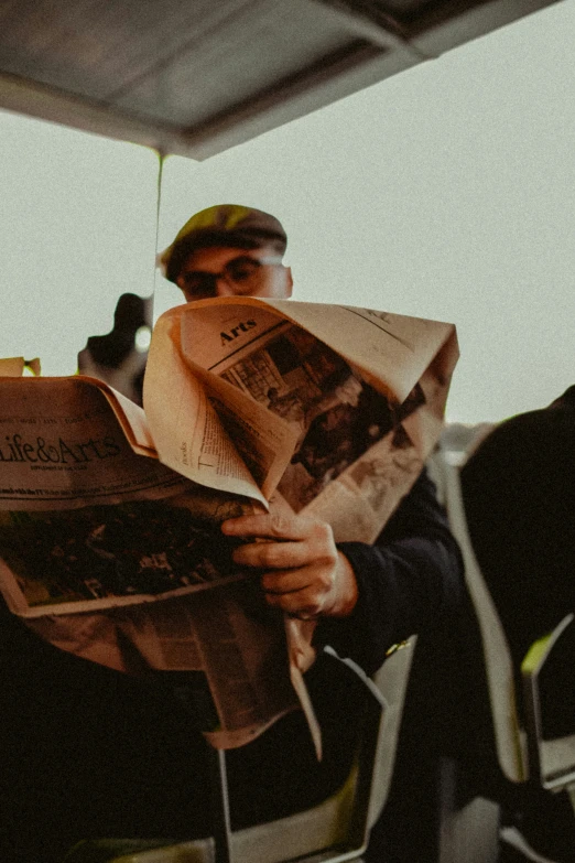 an image of a man reading a paper