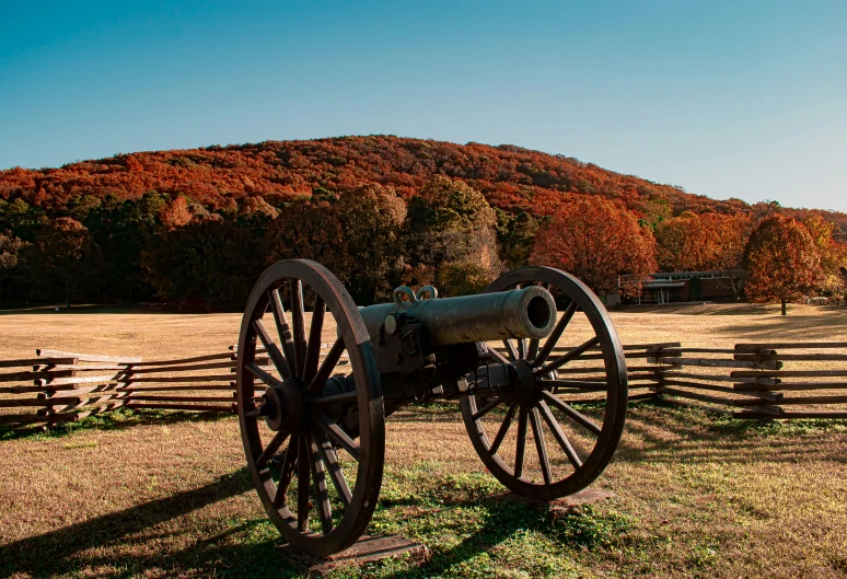 a civil war cannon is on display by a fence