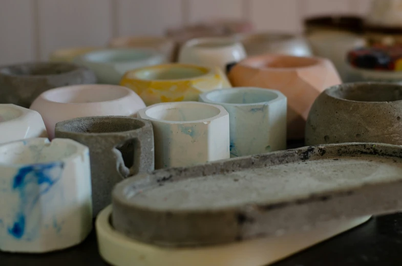 lots of pottery are shown sitting on the table