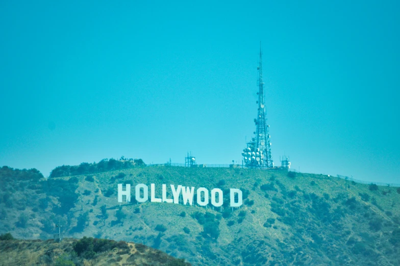 the hollywood sign stands on a hill with hills in the background