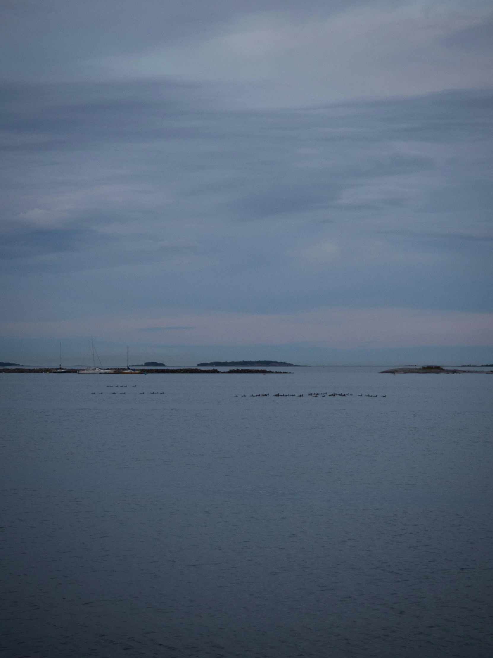 some very pretty light blue water under some cloudy skies