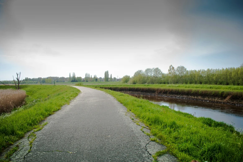 a paved road next to a body of water