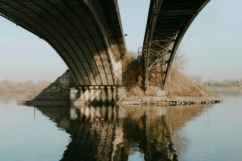 a boat traveling under a bridge that is over water