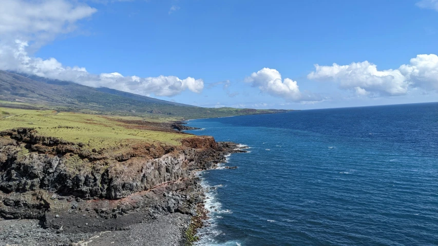 a scenic view of the ocean and mountains