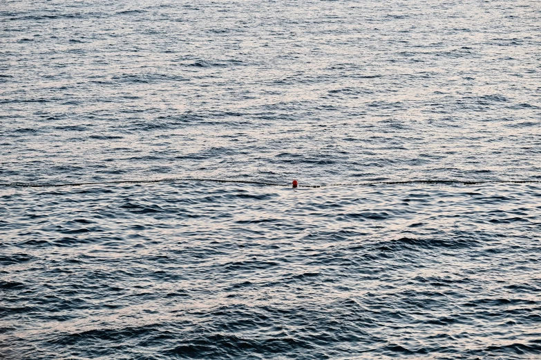 there is a small boat in the middle of the ocean