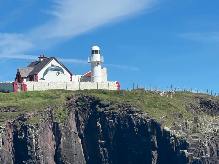 there is a house sitting on top of a cliff