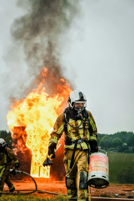 a firefighter using a hose near an open flame