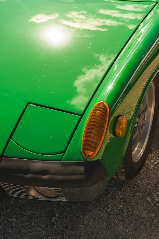 close up of the front bumper of a green sports car