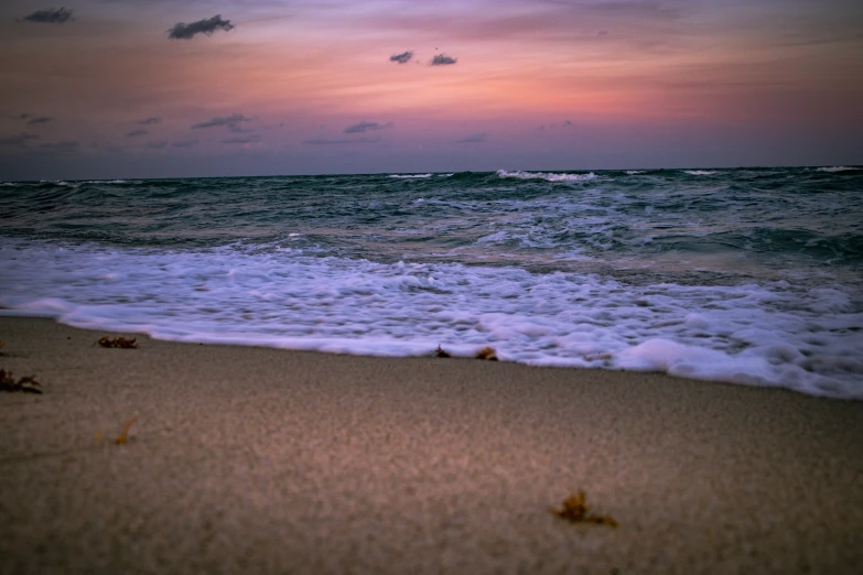 the ocean waves are rolling in on the beach