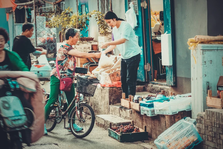 a couple of people with a bike in the street