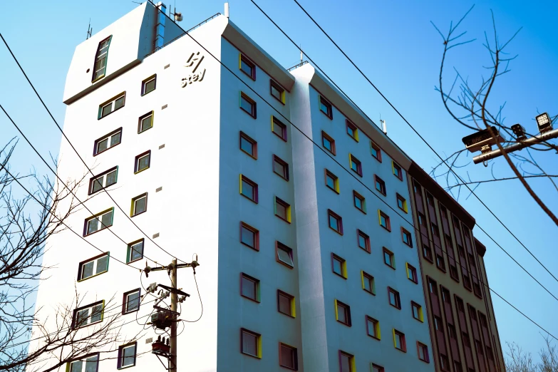 a tall building has two stories and lots of windows