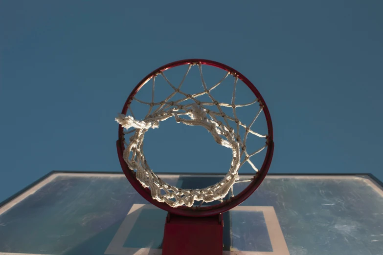 a basketball going through the rim of a hoop