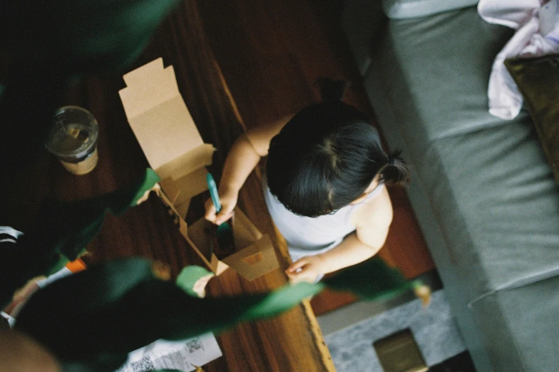 view from above of a person painting a wood wall