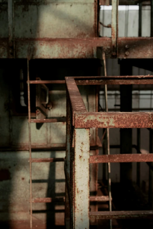 the rusty stair railing in a warehouse with metal bars