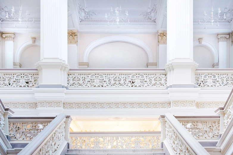 an open airy area with stairs and white wall