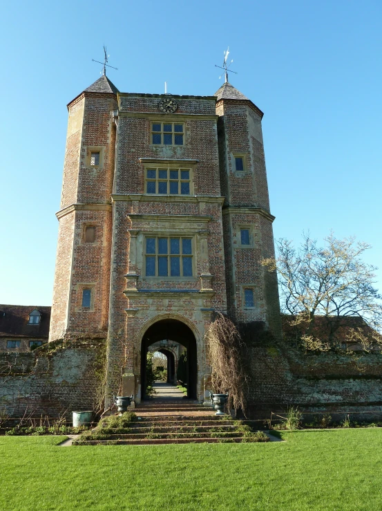 a building with a tall tower, and grass area